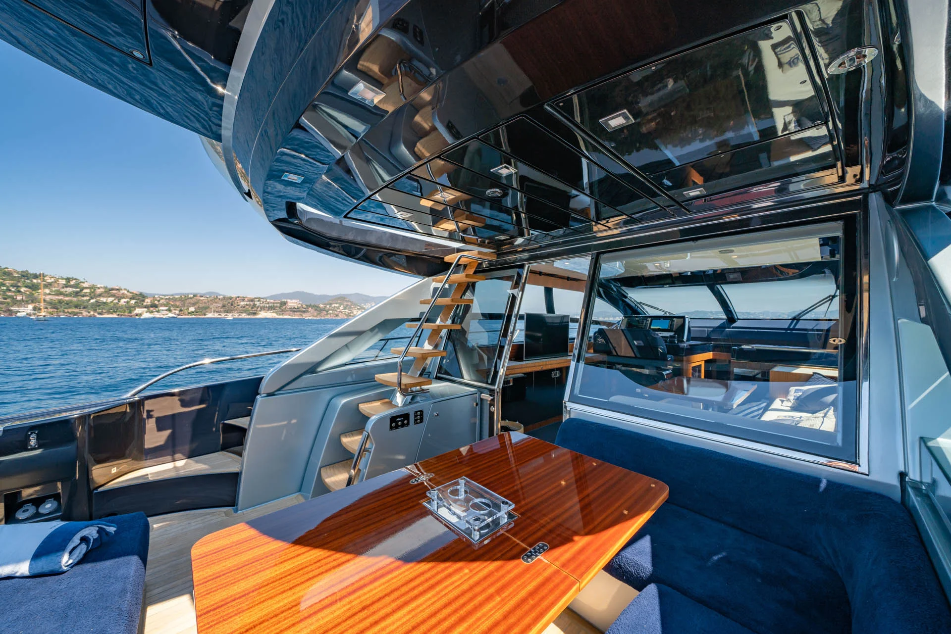 Aft deck lounge on BLUE SHARK yacht with Sardinia views.