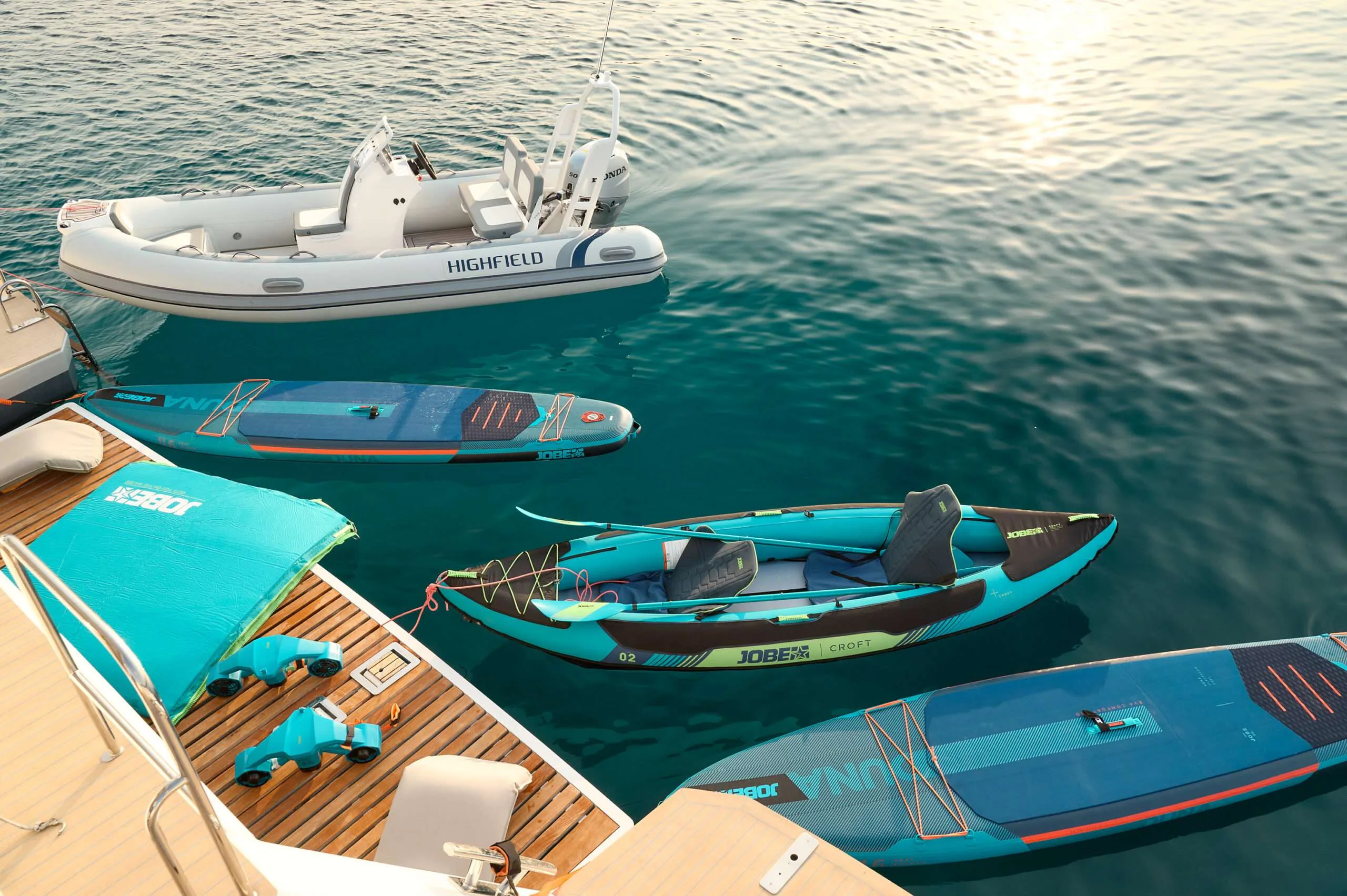 Stand-up paddleboards and tender next to FLORAMYE