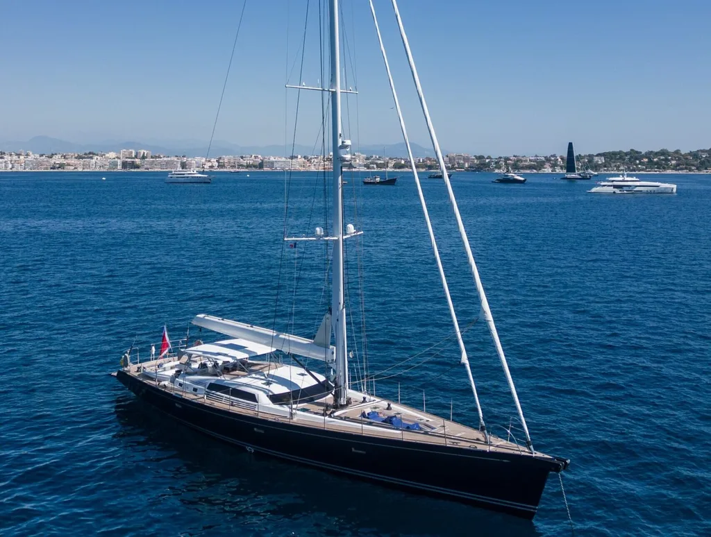 LADY 8 CNB 95 sailing yacht cruising near coastline.