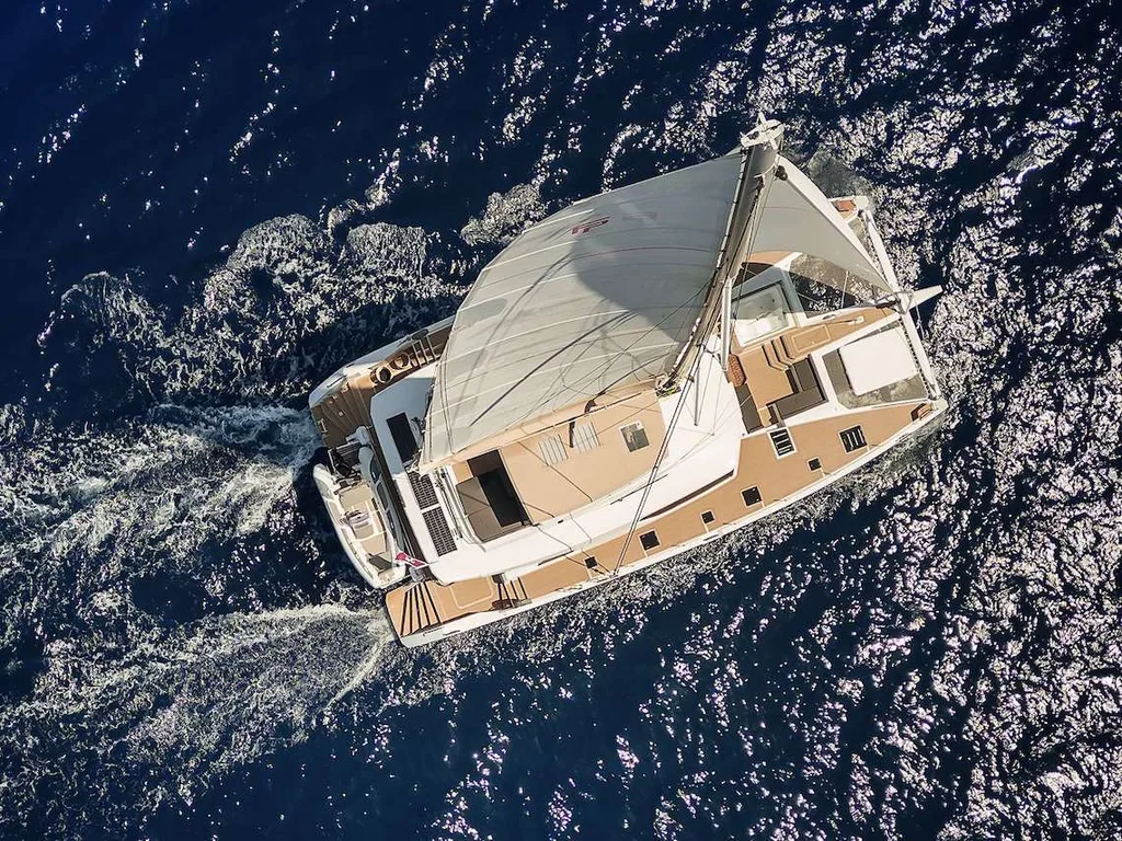 Aerial view of NEOW sailing with full sail