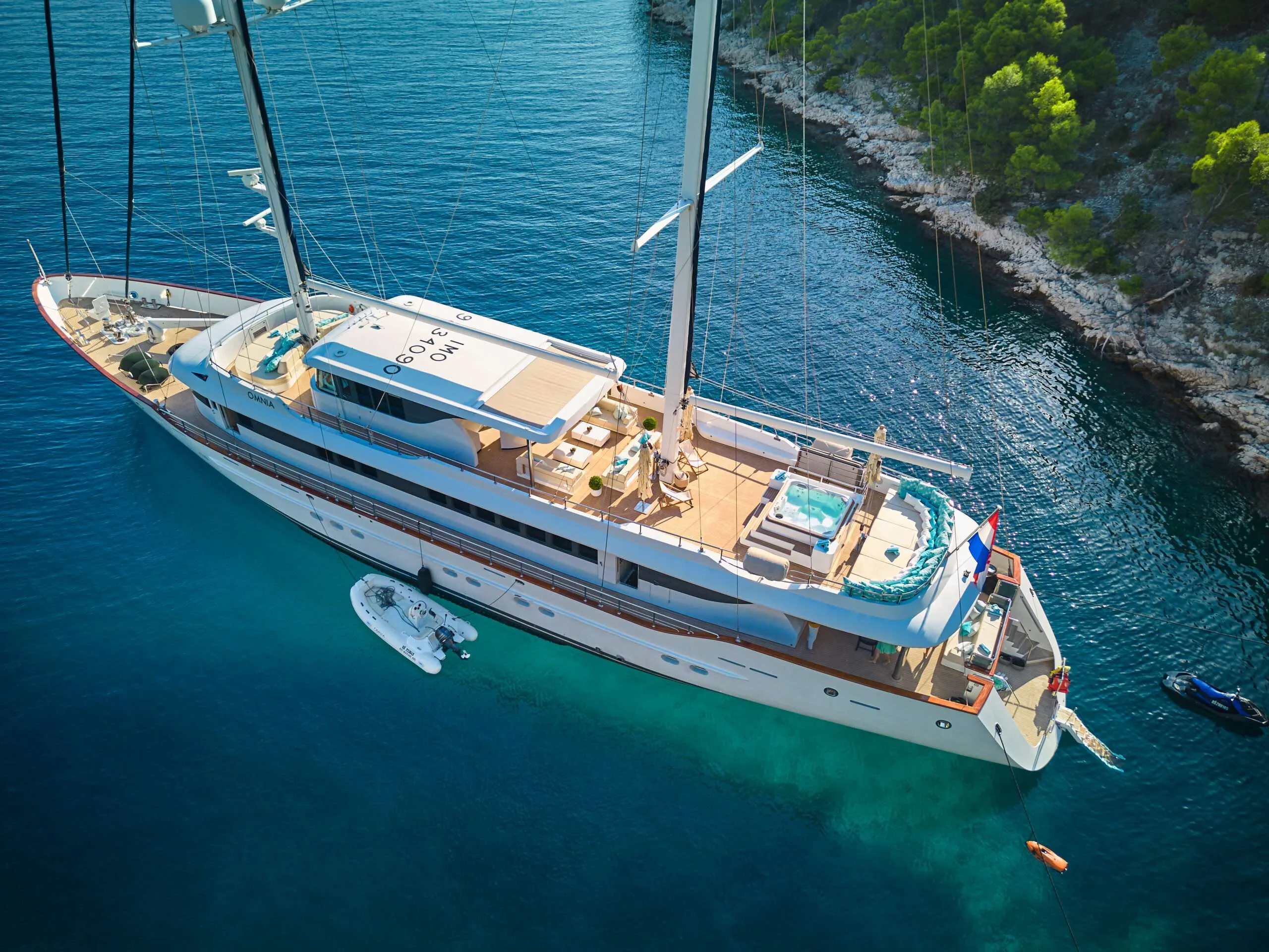 Aerial view of OMNIA anchored near the coastline