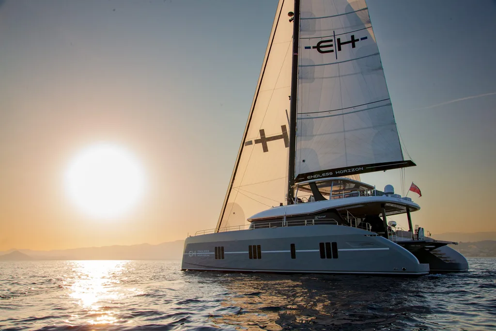 ENDLESS HORIZON Sunreef 80 sailing at sunset in the Caribbean.