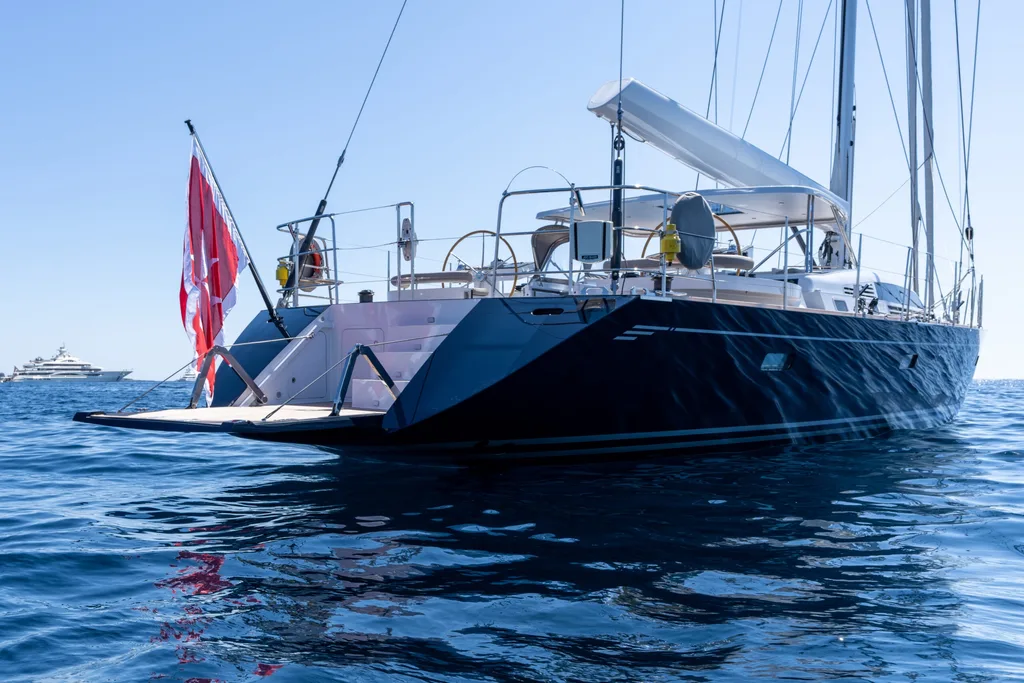 ADY 8 CNB 95 sailing yacht anchored on calm blue water.